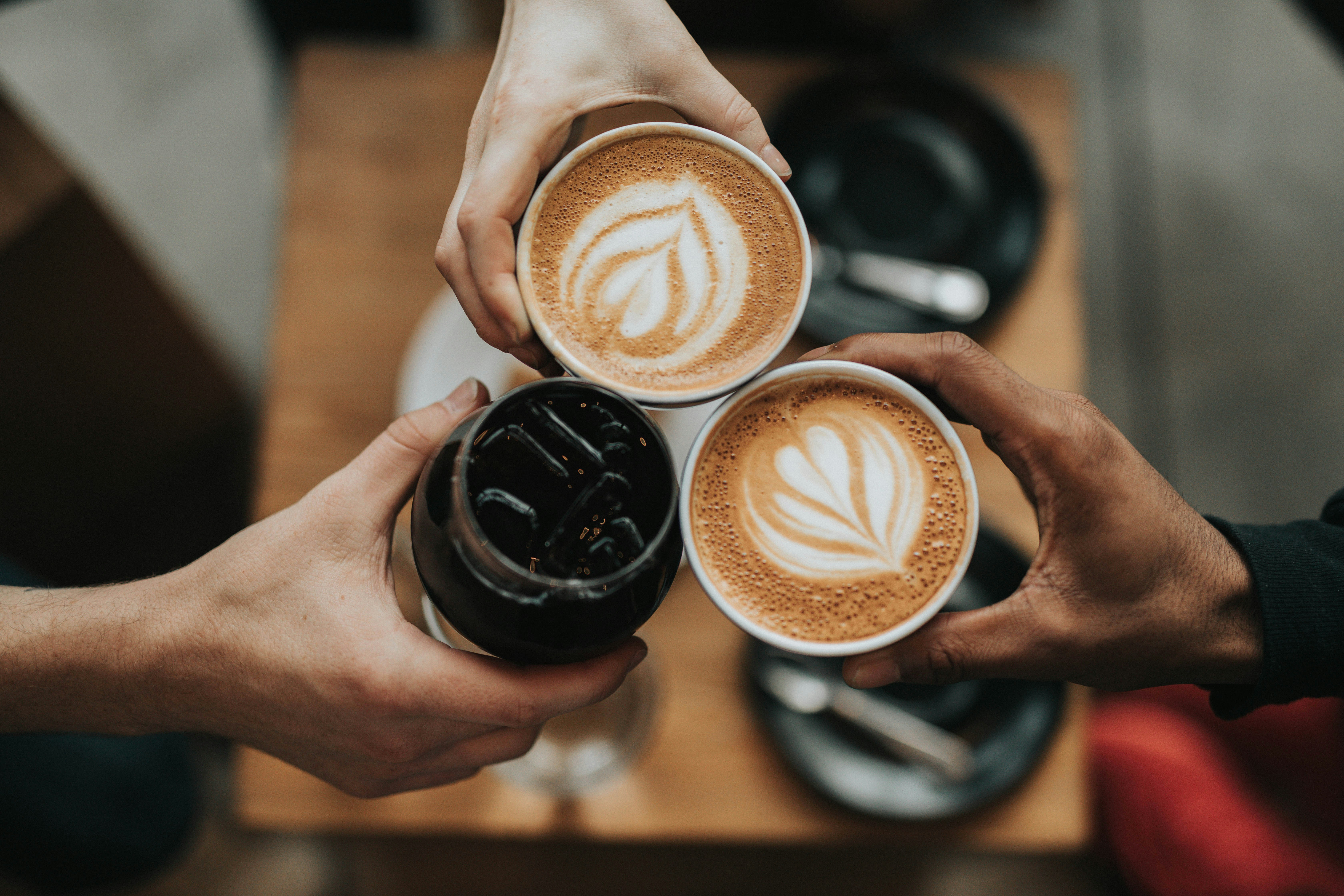 Picture of people holding coffee
